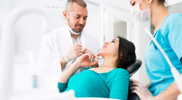 Dentists and dental hygienists at Friedman Dental Group engaging in a procedure, showcasing their commitment to providing top-tier, personalized dental care using modern technology.