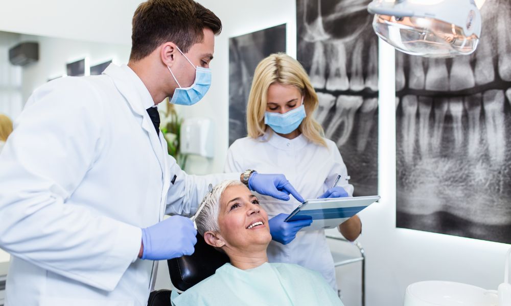 A compassionate dentist at Friedman Dental Group attending to a patient