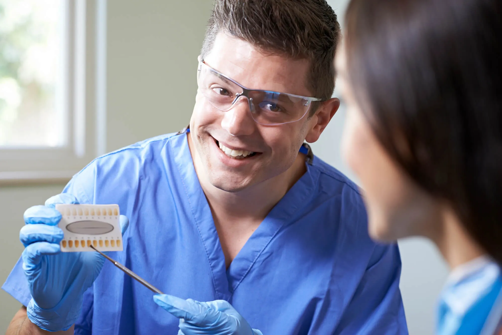 dentist and patient talking about cosmetic dentistry miami options