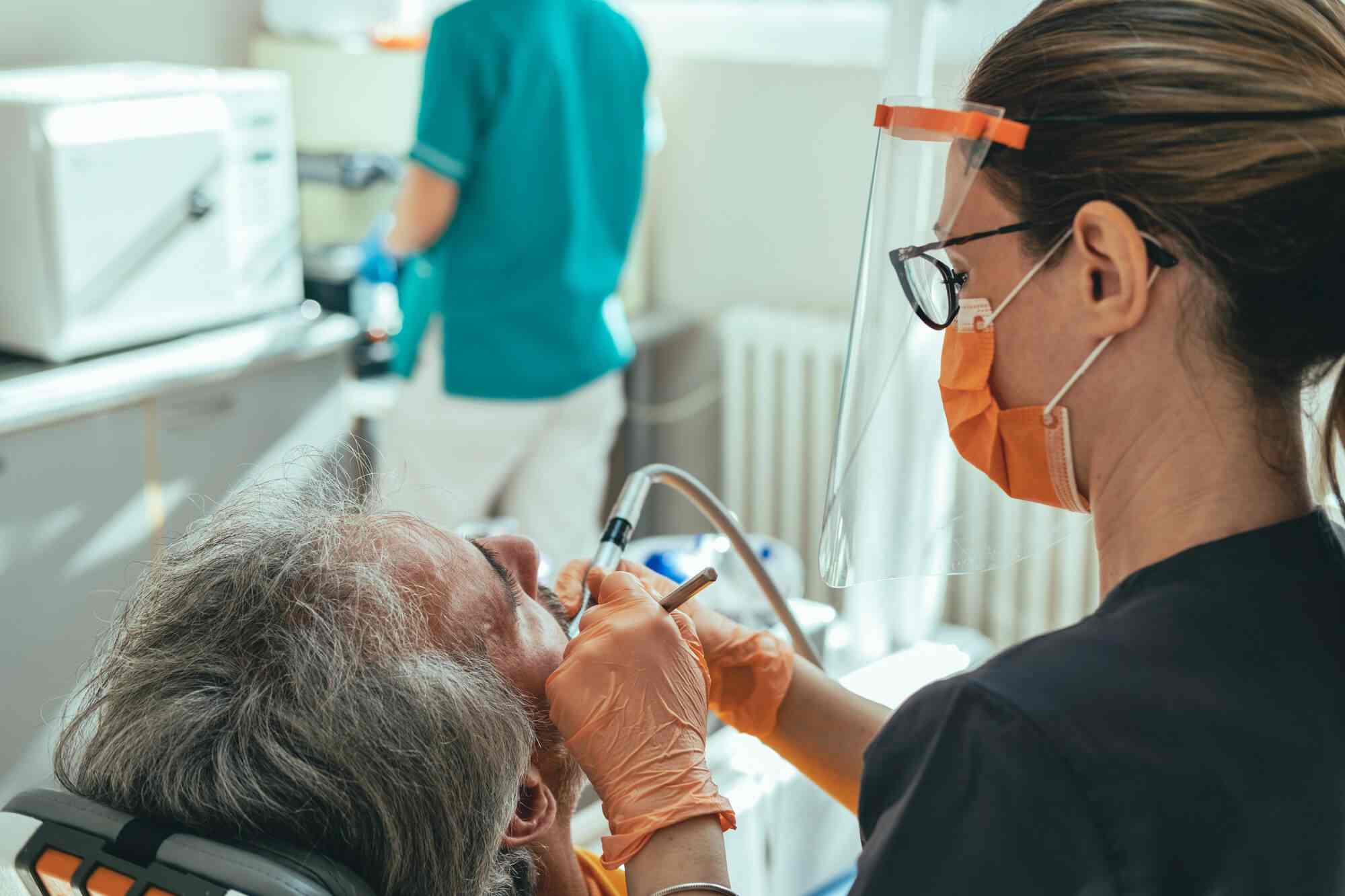 mergency dentist in Miami treating senior patient with dental emergency at Friedman Dental Group
