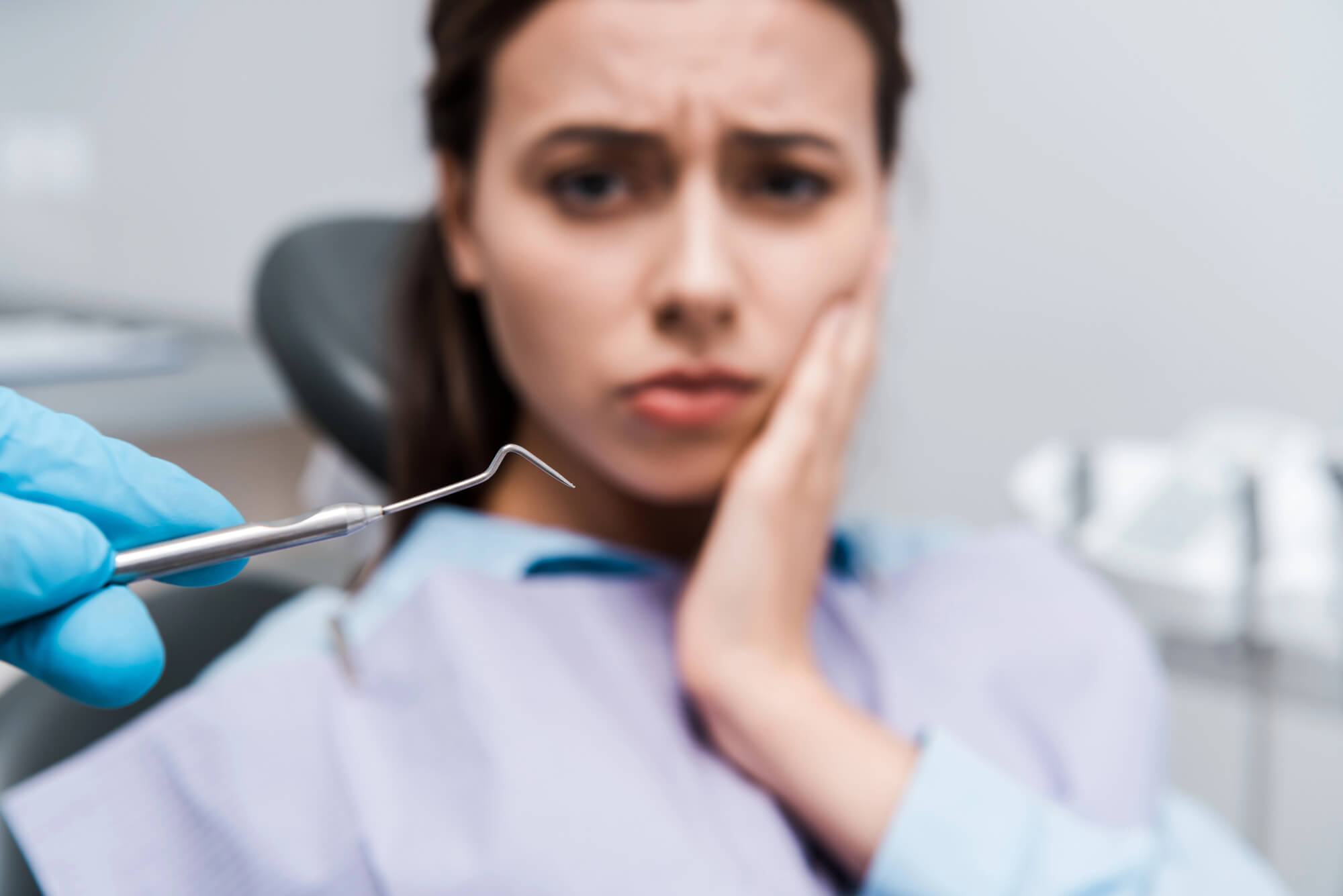 Woman experiencing dental emergency pain - Miami emergency dentist services at Friedman Dental Group