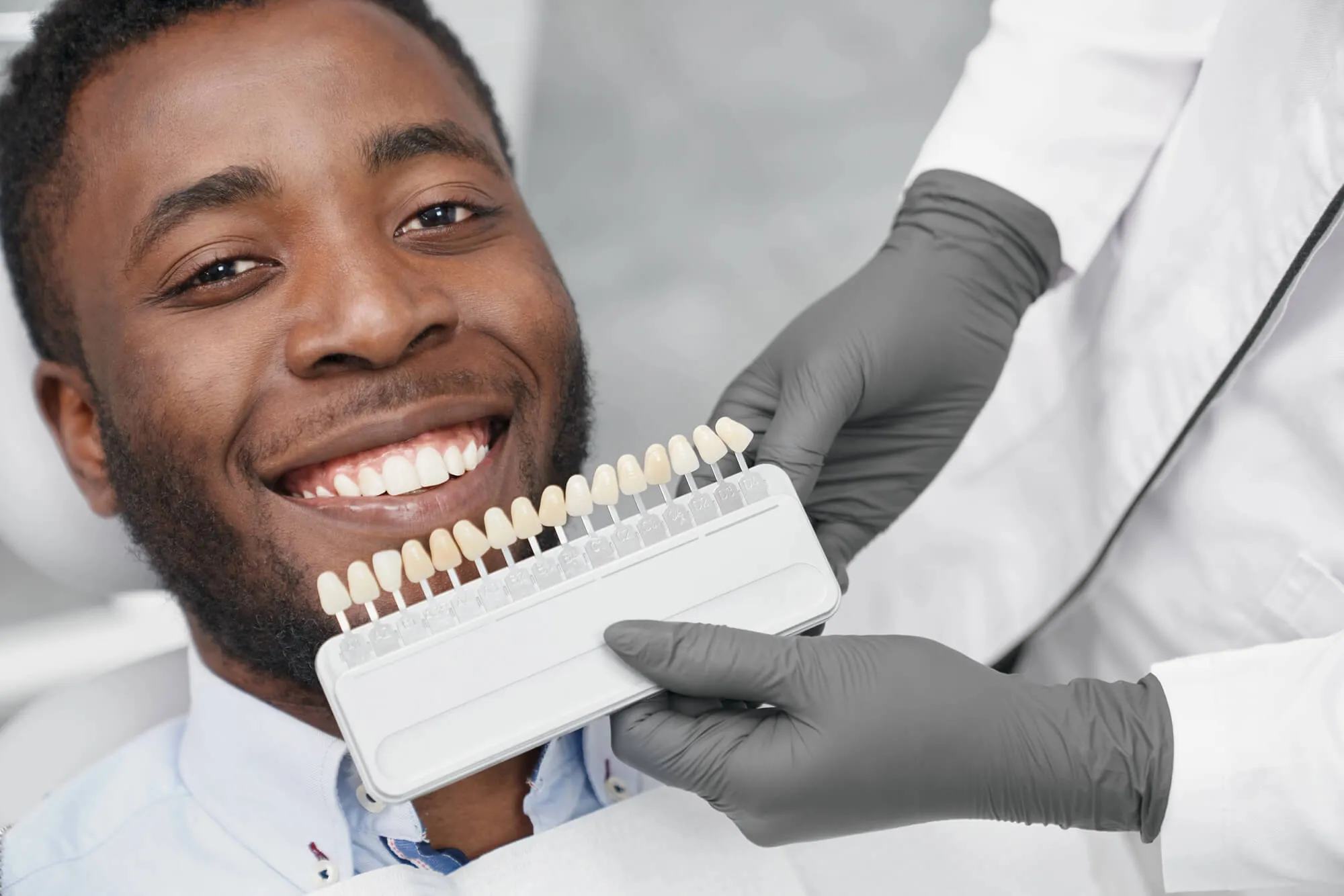 cosmetic-dentist-coral-springs-holding-out-a-shade-guide