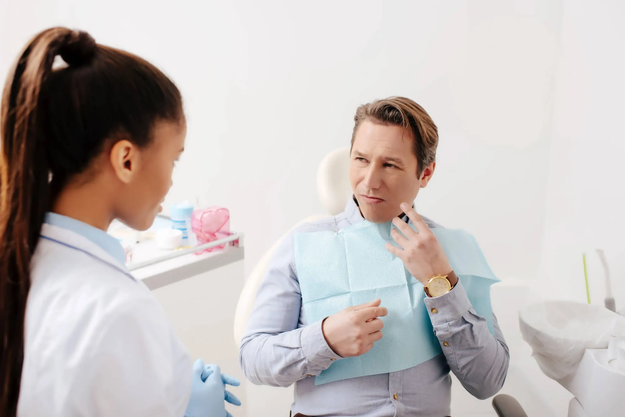 patient describing pain to his dentist tamarac cigna