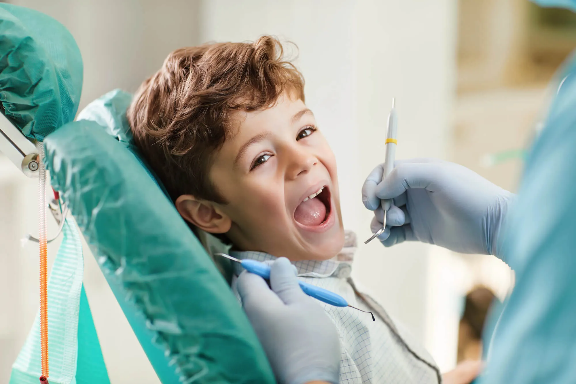 pediatric dentist coral springs delta dental checking patient's teeth