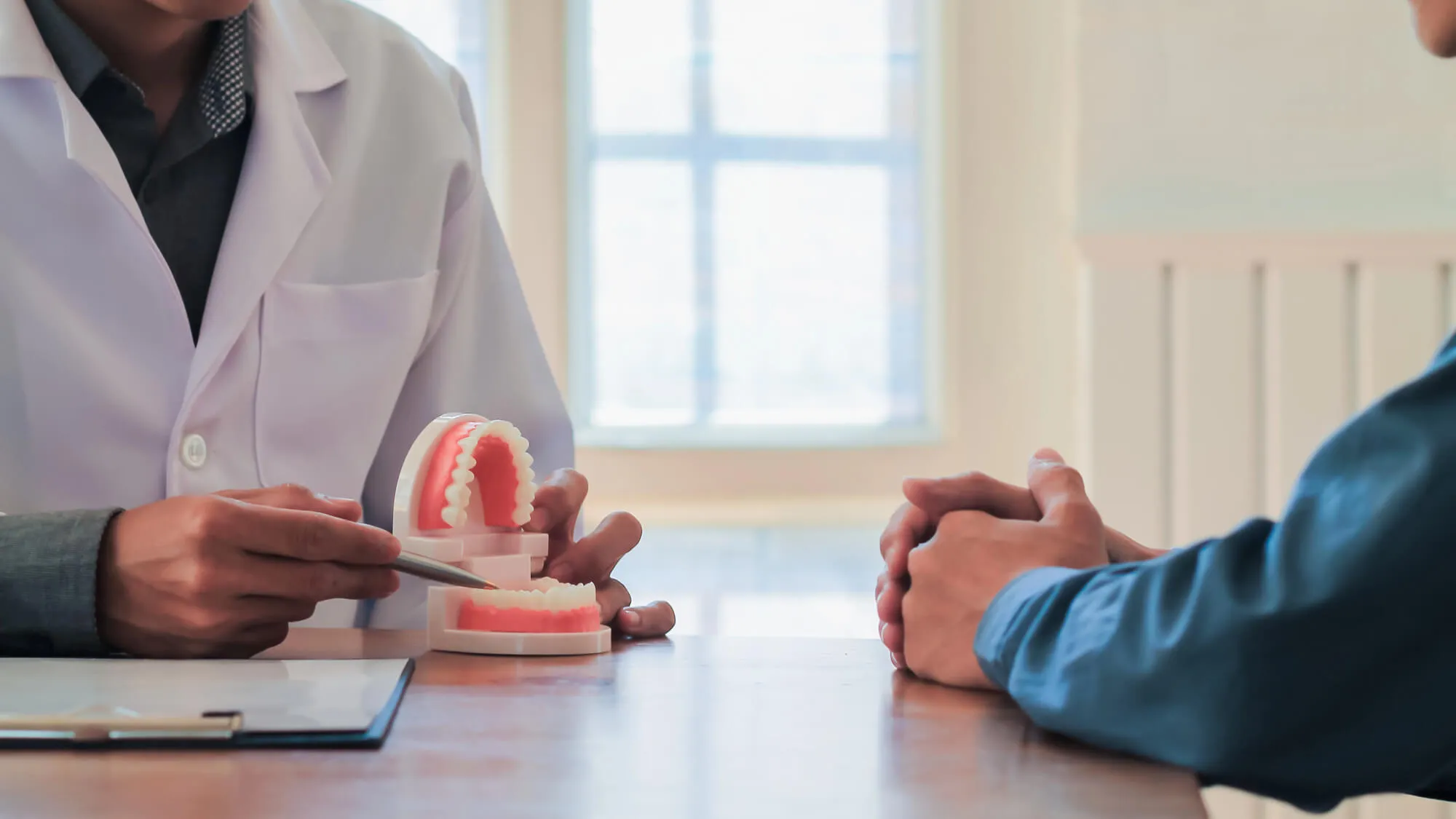 dentist explaining how to clean dentures tamarac
