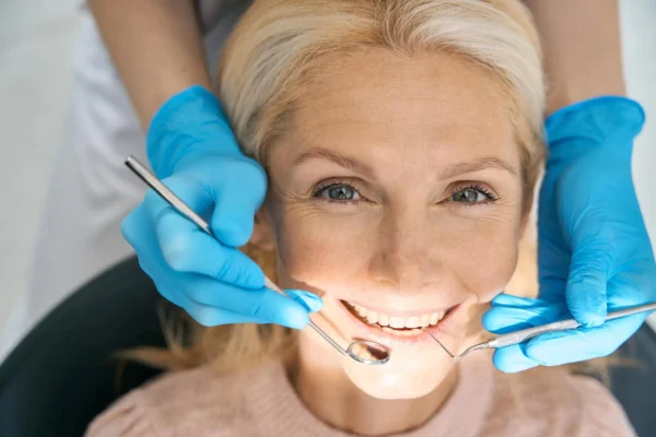 family dentist coral springs examines senior patient