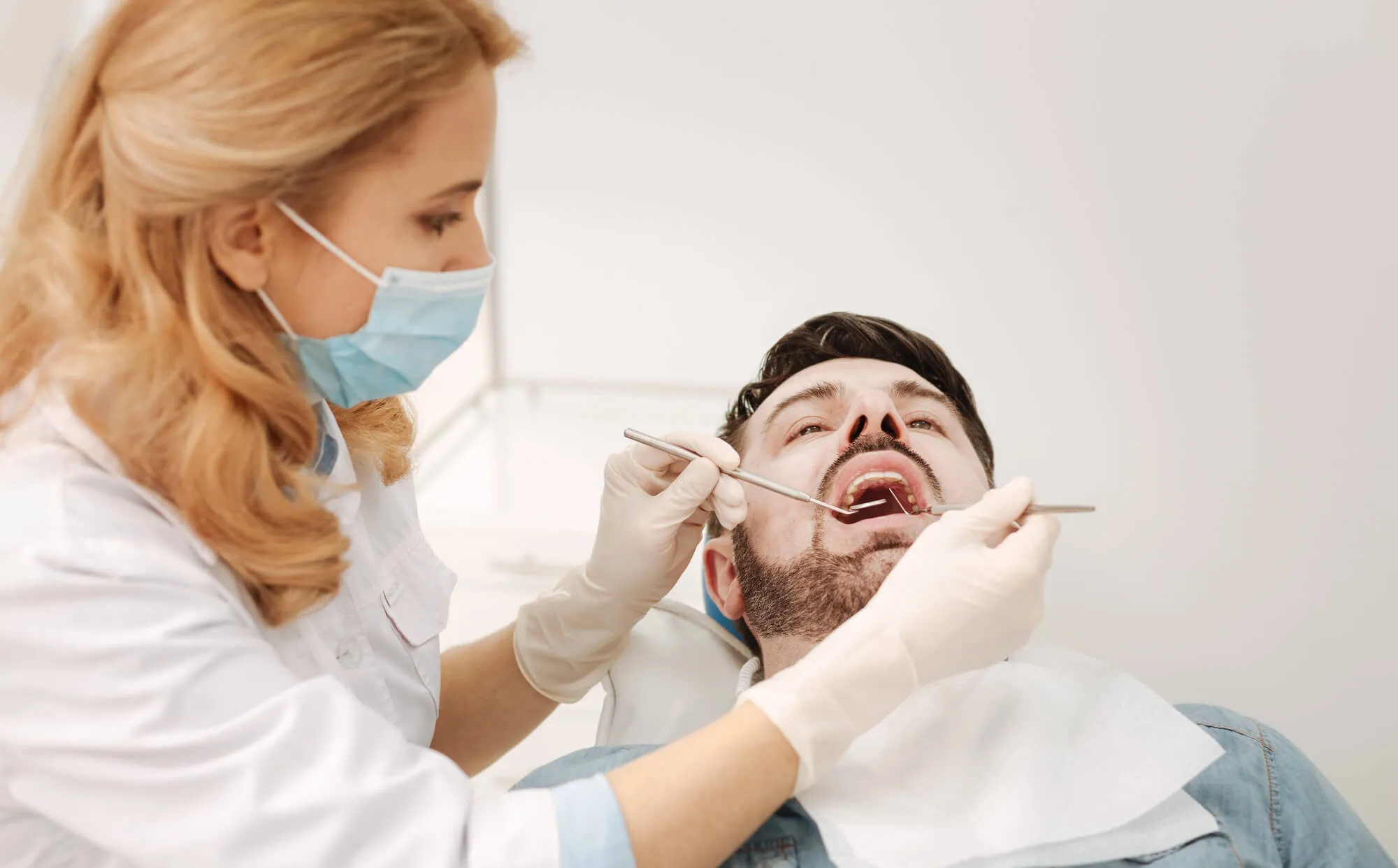 family dentist coral springs performs dental exam