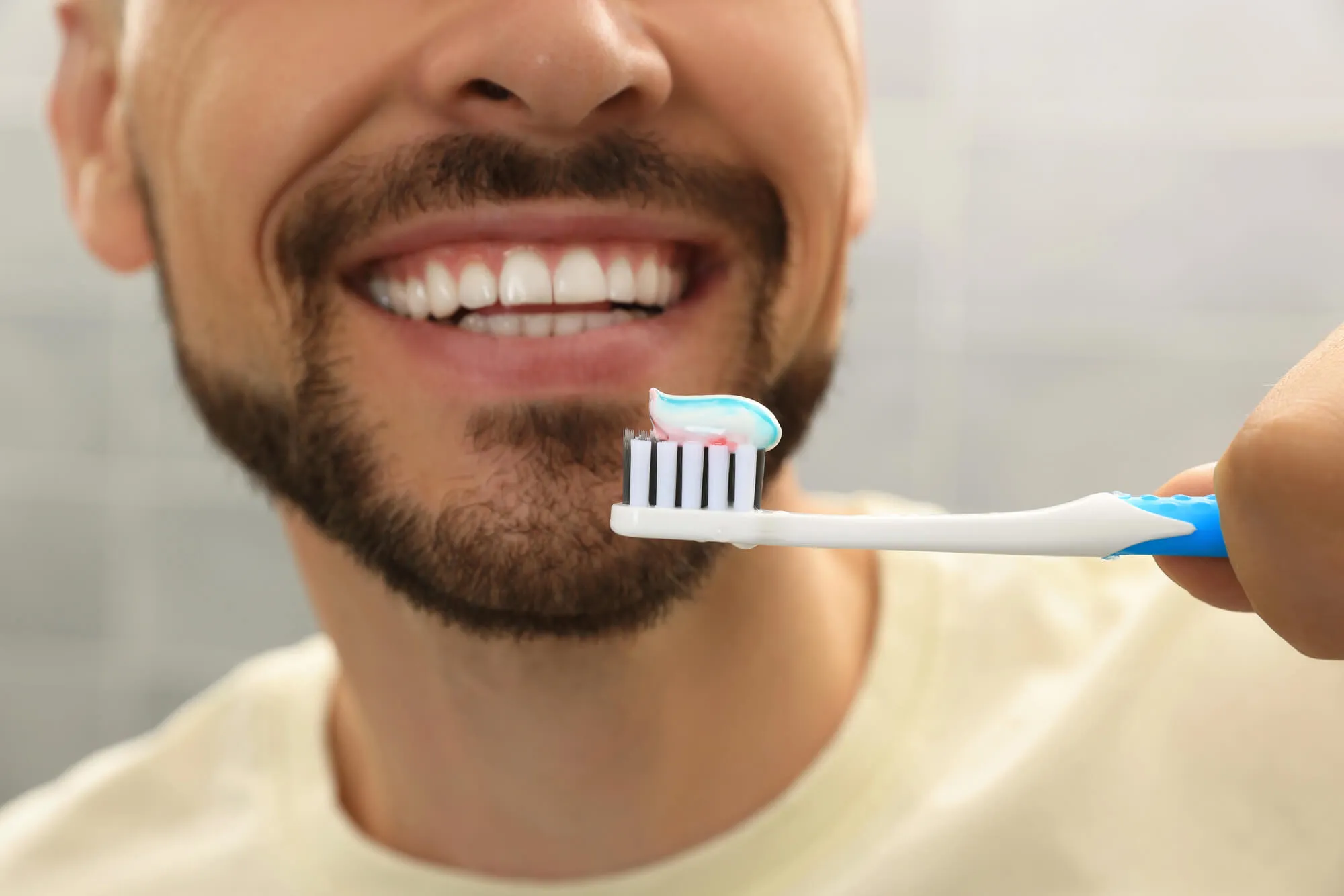 man brushing teeth as instructed by dentist coral springs